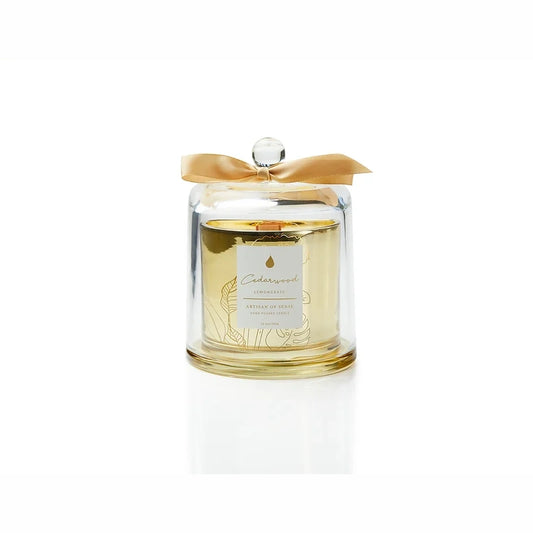 Gentle glow emanating from a soy candle featuring a natural fragrances and FSC wood wick, encased in an elegant gold glass container with a protective dome. Unique design and sustainable packaging. Scent: Cedarwood . Lemongrass.