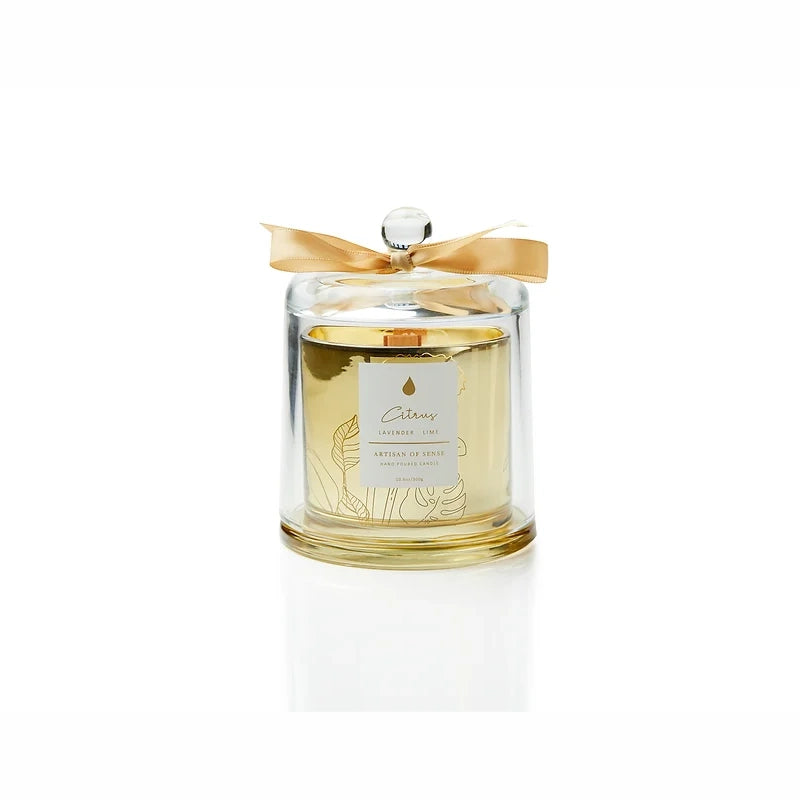 A beautiful gold glass jar holds a hand-poured soy candle with a natural FSC wooden wick, topped with a clear glass dome. The promise of a crackling flame and sustainable presentation makes it a wonderful gift. Scent: Oud . Rose . Amber.
