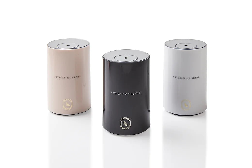Portable ultrasonic diffuser set in Pink, White, or Black, includes AOS Essential Oil Blend for on-the-go aromatherapy.