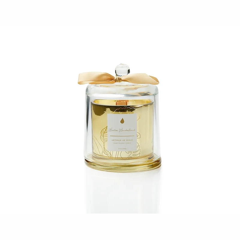Discover the charm of a crackling wooden wick candle with natural fragrances, a hand-crafted soy creation nestled in a chic gold glass jar and covered by a glass cloche. Its unique aesthetic and eco-friendly packaging make it an excellent gift choice. Scent: Winter Wonderland.