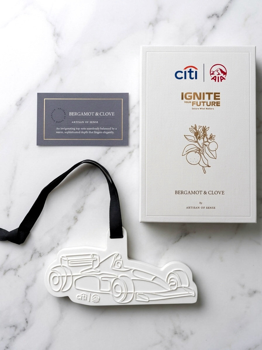 Bespoke scented ceramic ornament shaped like a race car with custom Bergamot and Clove packaging for Citi and AIA corporate gifting by Artisan of Sense.
