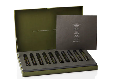 Artisan of Sense botanical body and room mist discovery set, its gift box opened to reveal a full row of natural fragrance rollerballs. Alcohol-free, plant-based blends handcrafted at our Joo Chiat atelier in Singapore, letting you explore the range across skin, linens, and interior spaces.