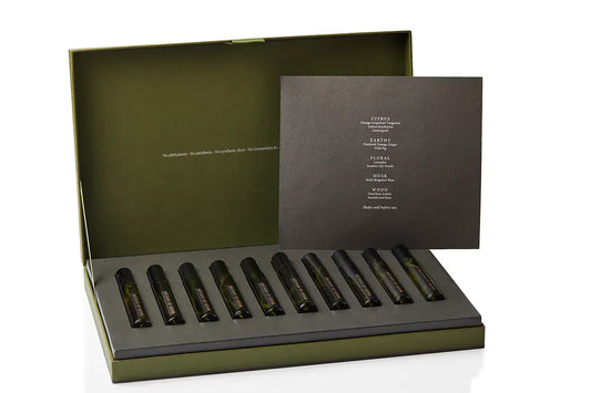 Artisan of Sense botanical body and room mist discovery set, its gift box opened to reveal a full row of natural fragrance rollerballs. Alcohol-free, plant-based blends handcrafted at our Joo Chiat atelier in Singapore, letting you explore the range across skin, linens, and interior spaces.