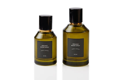 Artisan of Sense botanical body and room mist shown in two bottle sizes, each in olive green glass with a sleek black spray cap. Alcohol-free, plant-based interior and body fragrance handcrafted in Singapore using pure essential oils for wellness rituals and clean home scenting.