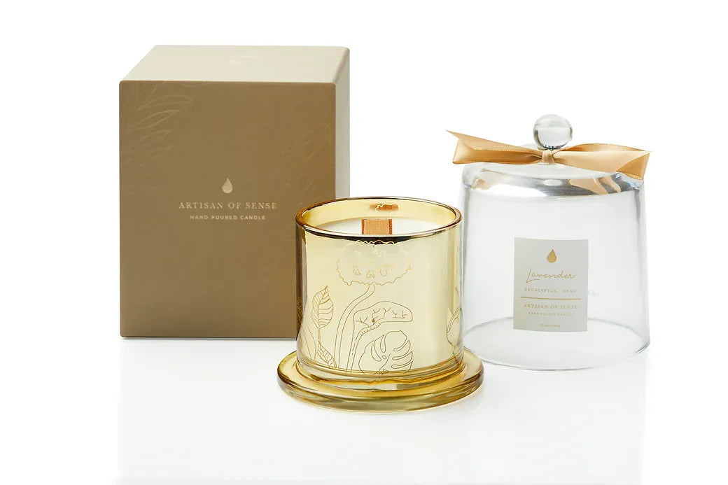 The warm light of a handcrafted essential oil soy candle, featuring an FSC-certified wooden wick for a gentle crackle. It rests within a sophisticated gold glass jar, protected by a dome, and comes in sustainable packaging, perfect for giving. Scent: Lavender . Eucalyptus . Sage.