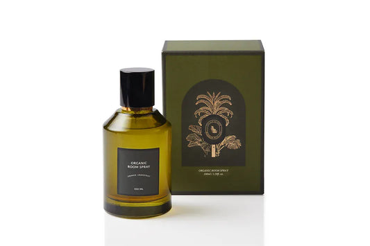 Aromatic botanical body and room mist in an elegant olive green glass bottle with black spray cap and gold accent, featuring cold-pressed Orange and Grapefruit peel. Alcohol-free natural spray handcrafted in Singapore for energising morning rituals and bright, optimistic interiors.
