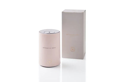 Portable ultrasonic diffuser set in Pink, White, or Black, includes AOS Essential Oil Blend for on-the-go aromatherapy.