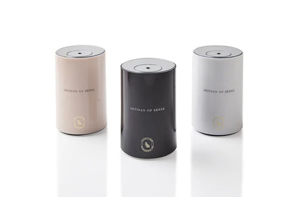 Portable ultrasonic diffuser set in Pink, White, or Black, includes AOS Essential Oil Blend for on-the-go aromatherapy.