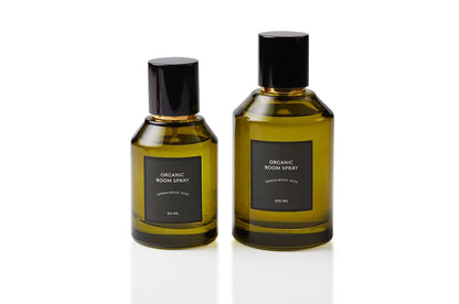 Sandalwood and Rose botanical body and room mist shown in two olive green glass sizes, each finished with a black spray cap. Non-toxic, plant-based natural fragrance handcrafted in Singapore for mindful self-care rituals, refreshed bed linens, and softly luxurious interior atmosphere.