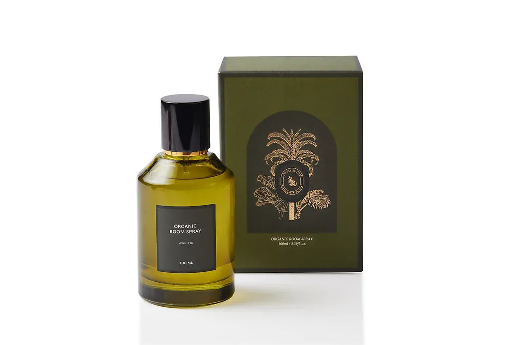 Botanical body and room mist in an elegant olive green glass bottle with black cap and gold accent, capturing green Wild Fig leaf and soft fruit. Alcohol-free, plant-based dual-purpose spray handcrafted in Singapore for lush Mediterranean warmth on skin, linens, and living spaces.