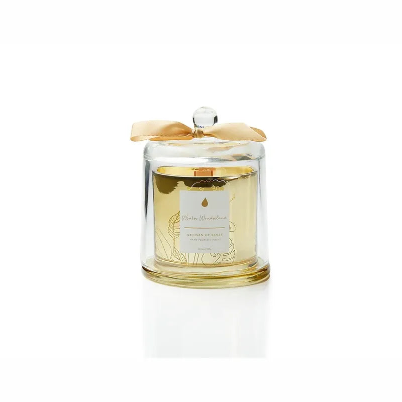 Discover the charm of a crackling wooden wick candle with natural fragrances, a hand-crafted soy creation nestled in a chic gold glass jar and covered by a glass cloche. Its unique aesthetic and eco-friendly packaging make it an excellent gift choice. Scent: Winter Wonderland.